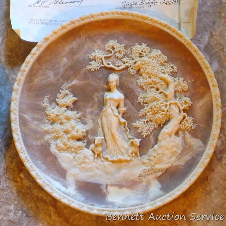 Two Incolay collector's plates with certificates of original ownership. One titled 'She Walks in