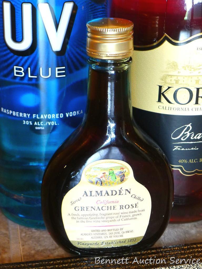 No shipping. Huge bottle Korbel brandy; liter bottle of UV Blue raspberry flavored vodka; small gift