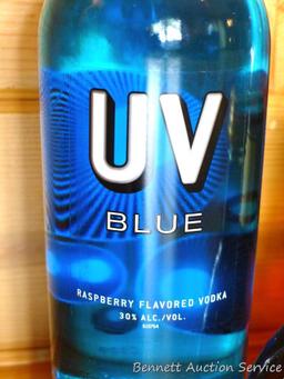 No shipping. Huge bottle Korbel brandy; liter bottle of UV Blue raspberry flavored vodka; small gift