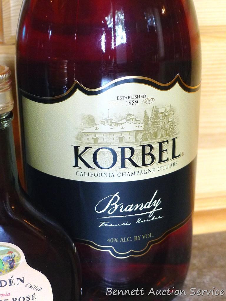 No shipping. Huge bottle Korbel brandy; liter bottle of UV Blue raspberry flavored vodka; small gift
