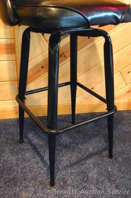 Steel framed swiveling bar stool is 43" tall. Nice and sturdy, vinyl in good condition.