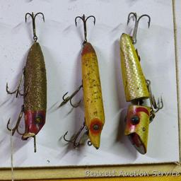 Old fishing lures, some with glass eyes. Longest body is 5".