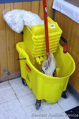 Rubbermaid commercial mop bucket with wringer includes mop and extra NIP mop head. Bucket is 16" x