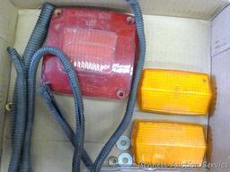 Two stop and turn taillights ( one is NIP), side marker lights, taillight lenses, more.