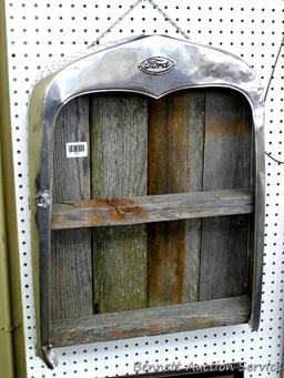 Model A radiator shell has been converted into a hanging barn board shelf. Measures approx 20" x
