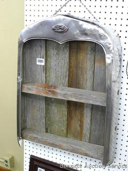 Model A radiator shell has been converted into a hanging barn board shelf. Measures approx 20" x