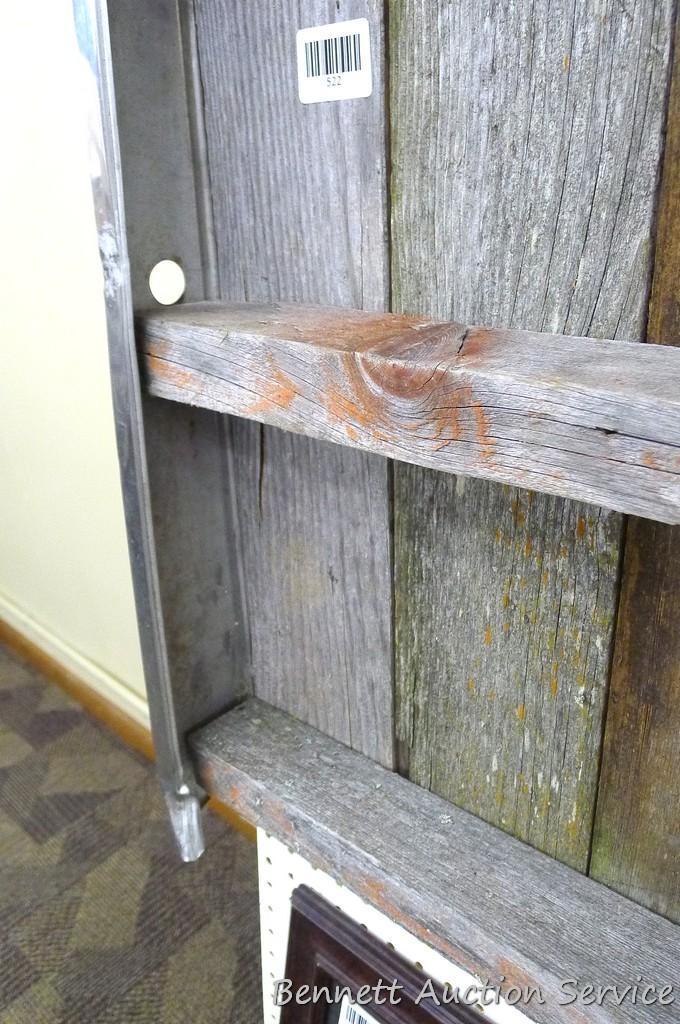 Model A radiator shell has been converted into a hanging barn board shelf. Measures approx 20" x