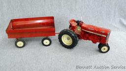 Ertl International tractor with No. 1349 wagon. Tractor with wagon is approx. 18" long.