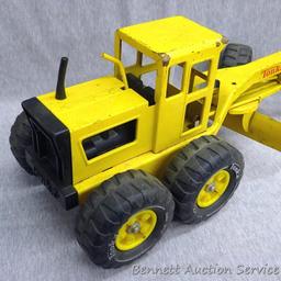 Tonka metal toy road grader is 18" x 7" x 7" tall. Wheels and blade rotate.