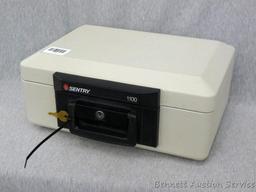 Sentry 1100 fire proof money safe; measures 14" x 10" x 6", looks new and comes with 1 key.