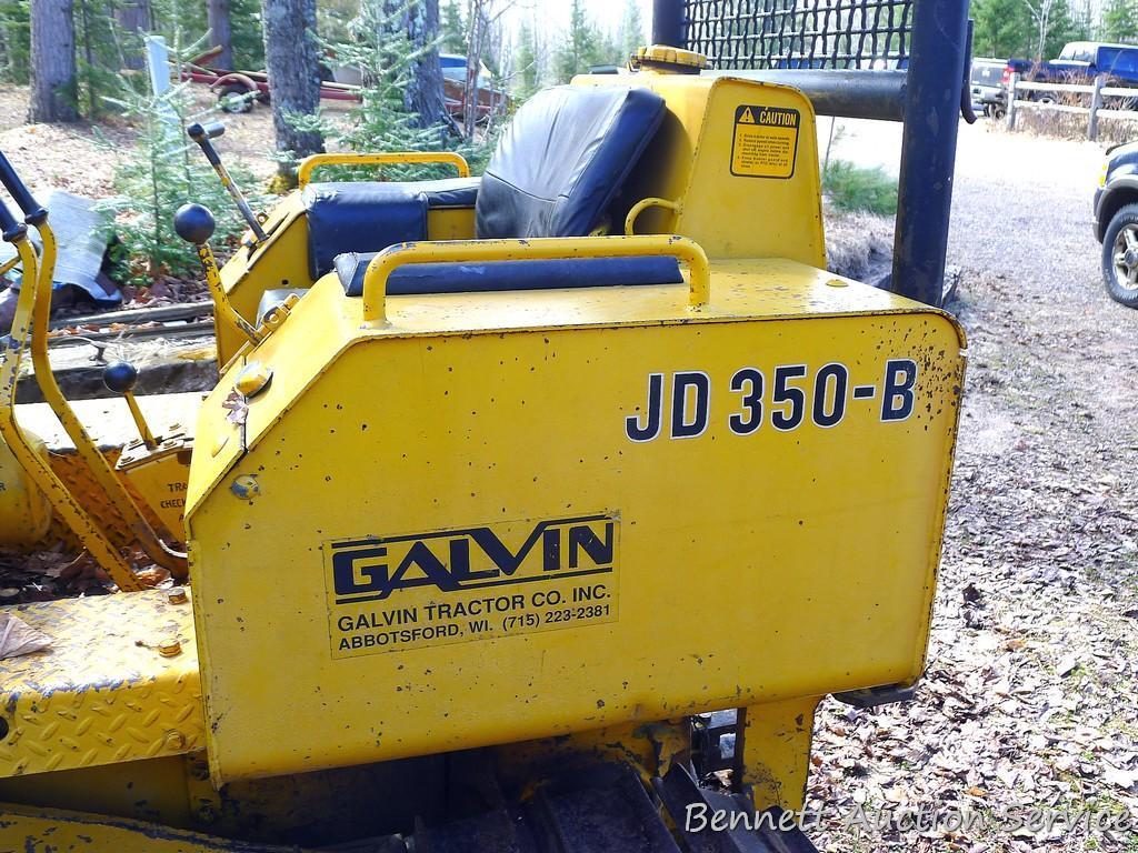 Watch the video. John Deere JD 350-B wide track dozer with 9 foot 6-way blade. Tracks are 32" wide.