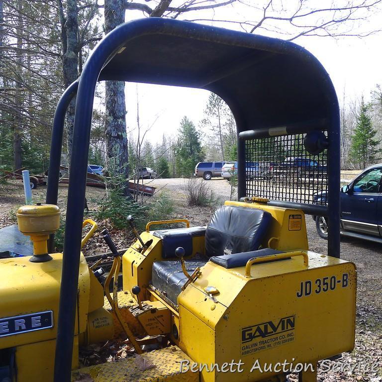 Watch the video. John Deere JD 350-B wide track dozer with 9 foot 6-way blade. Tracks are 32" wide.