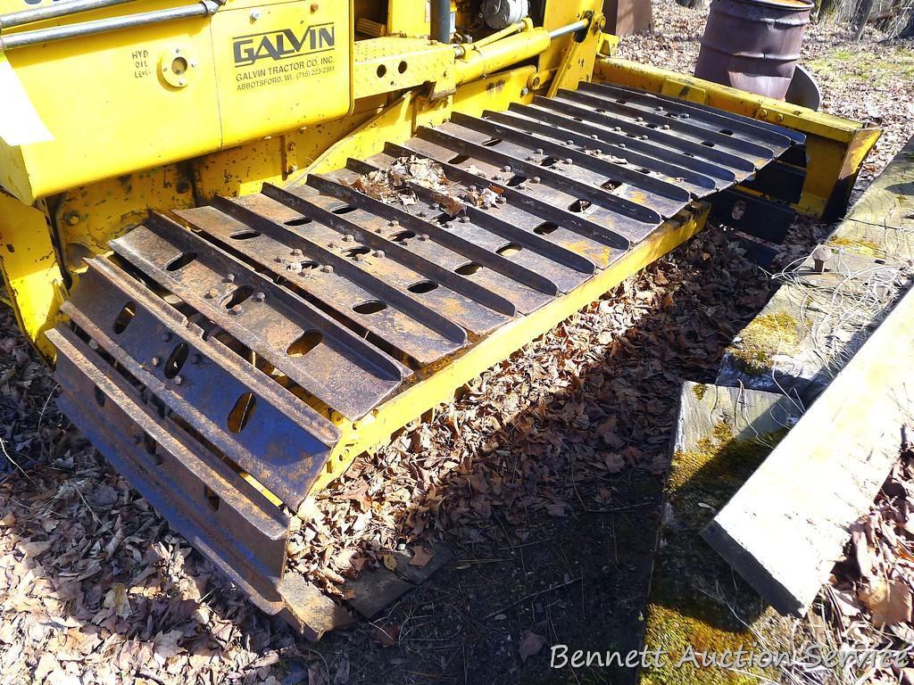 Watch the video. John Deere JD 350-B wide track dozer with 9 foot 6-way blade. Tracks are 32" wide.