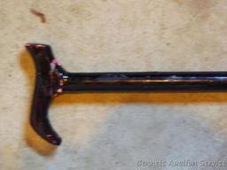 Leather and metal knee braces are old enough to decorate with. 34" cane has a slightly loose handle.