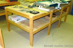Heavy duty homemade work table with lower shelf framed with 2x4 lumber is 48" x 98" x 35".