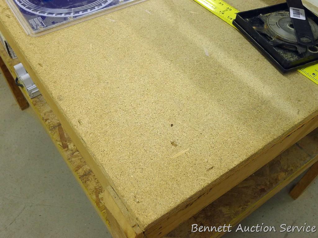 Heavy duty homemade work table with lower shelf framed with 2x4 lumber is 48" x 98" x 35".