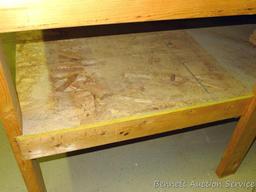 Heavy duty homemade work table with lower shelf framed with 2x4 lumber is 48" x 98" x 35".