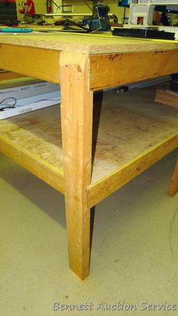 Heavy duty homemade work table with lower shelf framed with 2x4 lumber is 48" x 98" x 35".