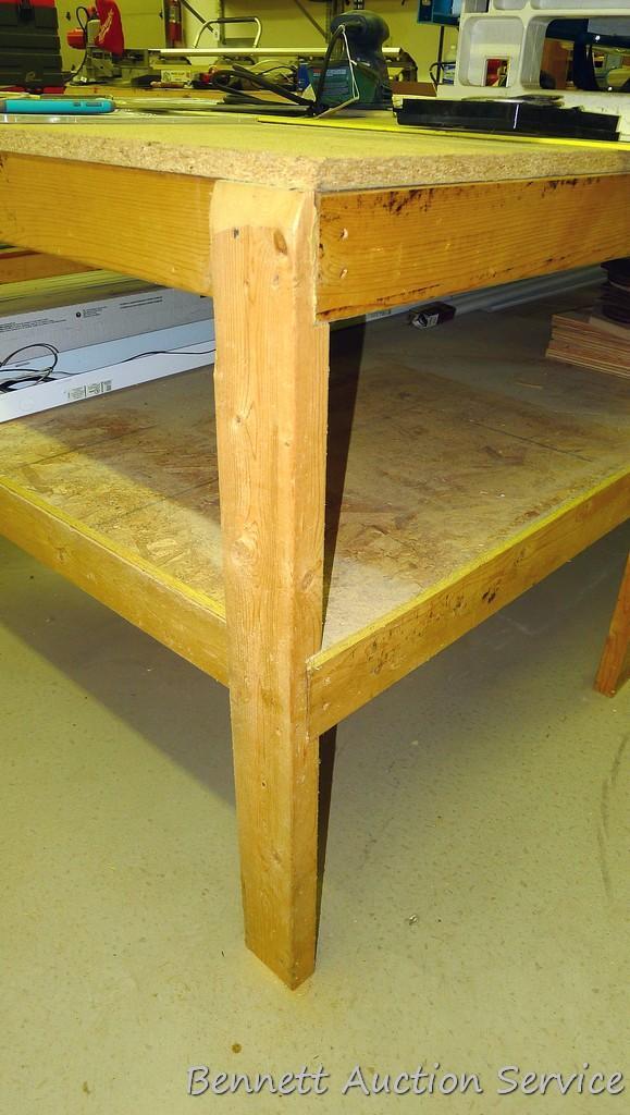 Heavy duty homemade work table with lower shelf framed with 2x4 lumber is 48" x 98" x 35".