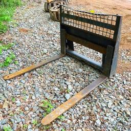 Quick connect pallet forks for Bobcat or other skid steer. Forks are 4' long, 4" wide. Back board is