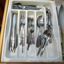 Stainless steel flatware set, plus two Pampered Chef knives and some other knives.