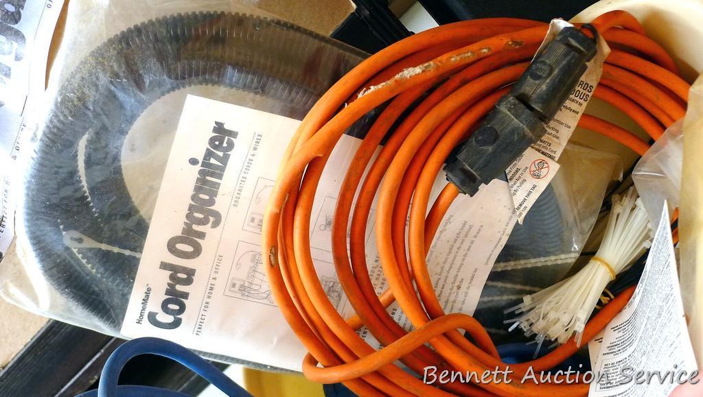 Three extension cords; 8 ft. flexible cord organizer; 2 new pkgs. Weld It all purpose adhesive; lots