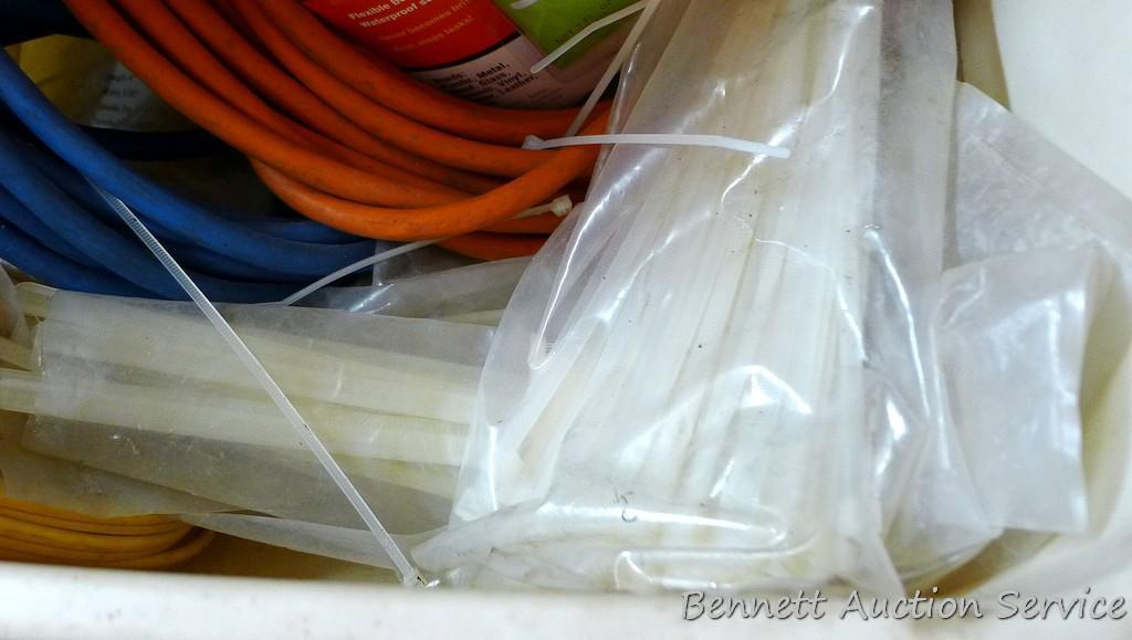 Three extension cords; 8 ft. flexible cord organizer; 2 new pkgs. Weld It all purpose adhesive; lots