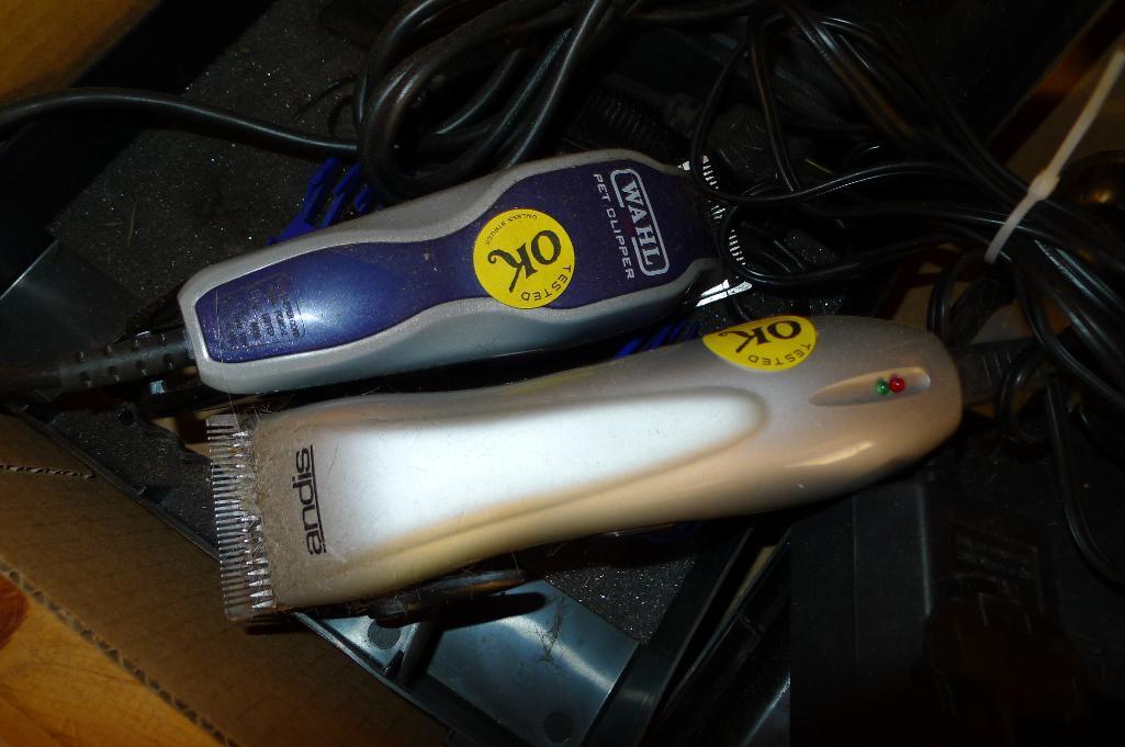 Andis and Wahl pet trimmers or clippers, both run. Wahl trimmer makes a popping sound when started.