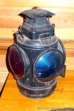 Adlake four-way railroad lantern is marked "The Adlake Non-Sweating Lamp Chicago". Two blue lenses