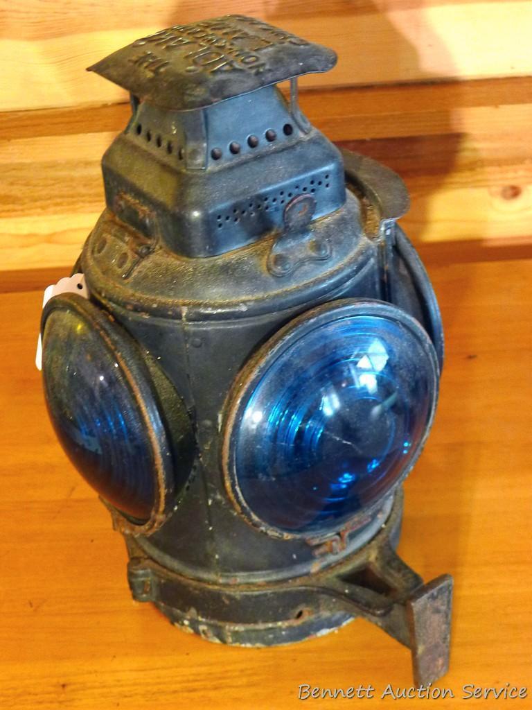 Adlake four-way railroad lantern is marked "The Adlake Non-Sweating Lamp Chicago". Two blue lenses