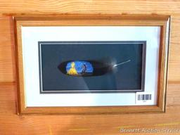 Pretty framed and matted feather has been painted with a Native American scene. Approx 15" x 10"