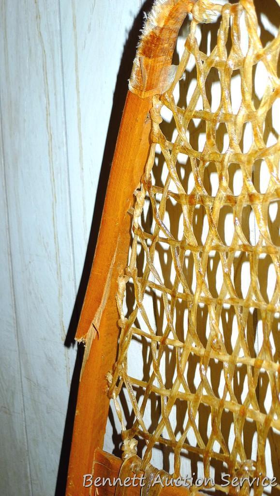 Pair of Safesport Northwoods Brand snowshoes. Both shoes have breaks in the frame. Both shoes