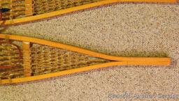 Pair of Safesport Northwoods Brand snowshoes. Both shoes have breaks in the frame. Both shoes