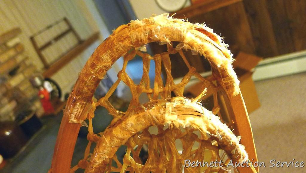 Pair of Safesport Northwoods Brand snowshoes. Both shoes have breaks in the frame. Both shoes