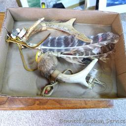 Whitetail deer antlers have been decorated with fur, feathers and leather. Each is approx. 8".