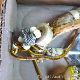 Whitetail deer antlers have been decorated with fur, feathers and leather. Each is approx. 8".