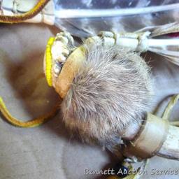 Whitetail deer antlers have been decorated with fur, feathers and leather. Each is approx. 8".