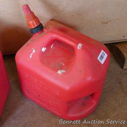 Two 5 gallon gas totes have a little liquid in bottoms. If shipped will be emptied for a fee.