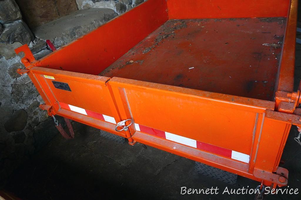 Large utility trailer with hand pump hydraulic dump is of all steel construction. Box is 53" x 74" x