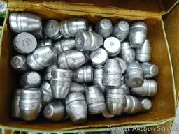 Assorted cast lead bullets including round nose, flat cone nose, Spitzer, capped base, more.