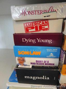 Stack of VHS movies including Pearl Harbor; American Pie; The Net; Magnolia; Dying Young; Shrek;