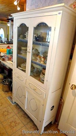 Very charming cabinet with glass doors on top, the drawers and paneled doors have a pressed design