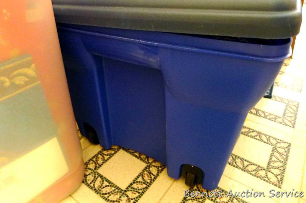 Chest style tote has wheels on one side for easy moving. Tote is filled with gift bags, bows,