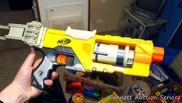 Tub of toys includes some K'Nex; Nerf rifle; set of 4 water Blasters; ceramic military dressed piggy