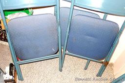 Set of four metal folding chairs with padded seats and backs in good condition.