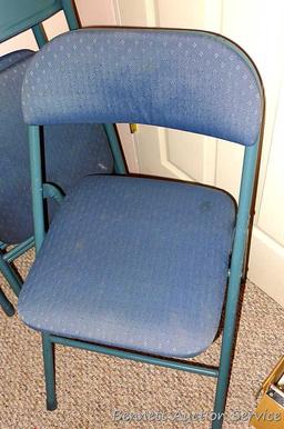 Set of four metal folding chairs with padded seats and backs in good condition.