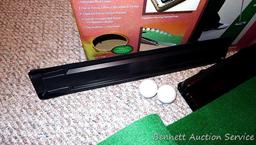 Club Champ Automatic Putting System for indoor practice and a box full of golf balls.