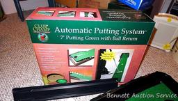 Club Champ Automatic Putting System for indoor practice and a box full of golf balls.