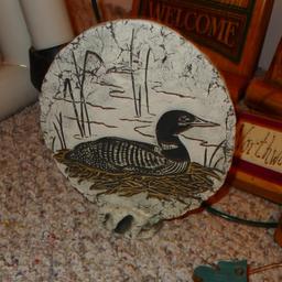 Clay standup disc of a loon made with Mt. St. Helens' Ash is 7" diameter; sturdy metal grapevine