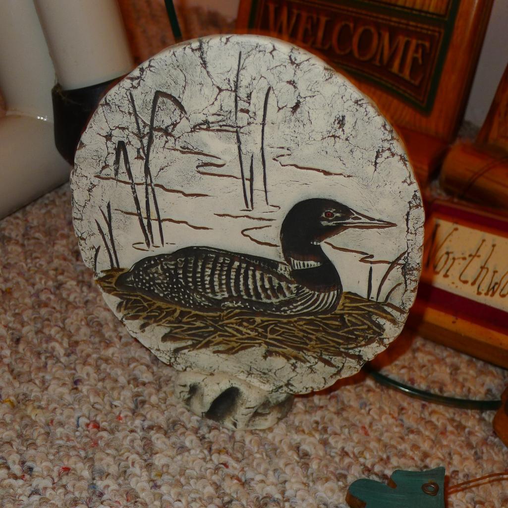 Clay standup disc of a loon made with Mt. St. Helens' Ash is 7" diameter; sturdy metal grapevine